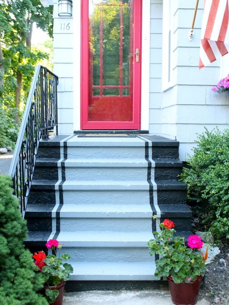 Picture of bright painted door and steps with pots of flowers