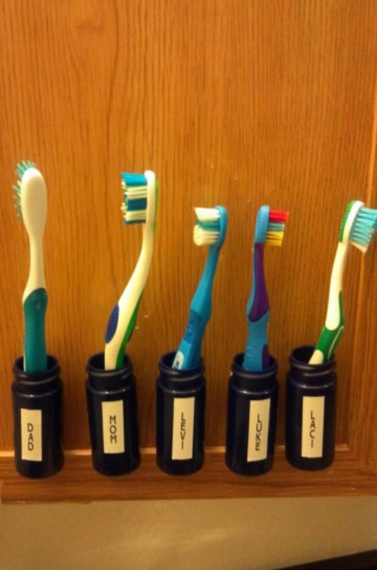 Crafty Pill Bottle Toothbrush Holders labeled with family members names