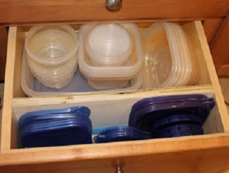 One Crazy House how to Organize Kitchen open kitchen drawer with plastic containers, lids neatly stacked in section divided by wood plank