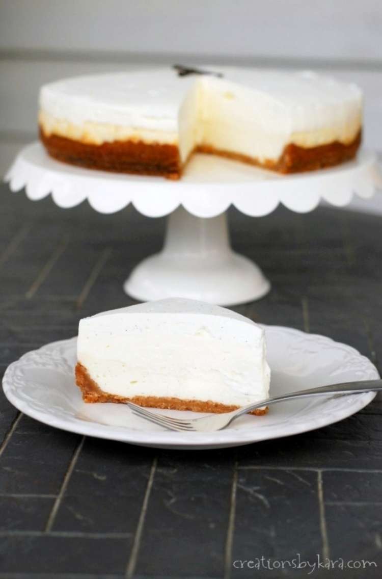 OneCrazyHouse Cheesecake Factory Copycat recipes Vanilla bean cheesecake on elevated cake stand with slice of the cheescake on a slice in front of cake stand. 