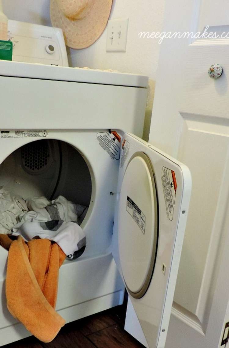 OneCrazyHouse Fastest way to dry clothes clothes dryer open filled with clothes with a towel hanging out of the front.