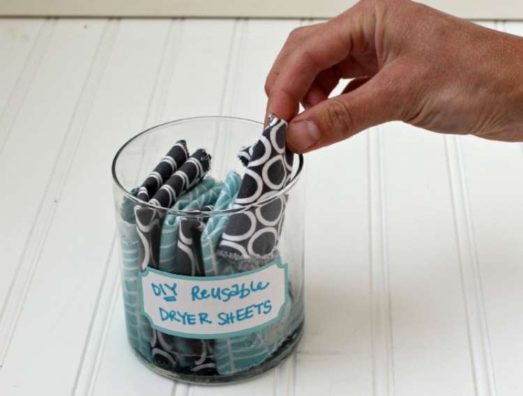 OneCrazyHouse Fastest way to dry clothes hand reaching into a glass container filled with DIY dryer sheets