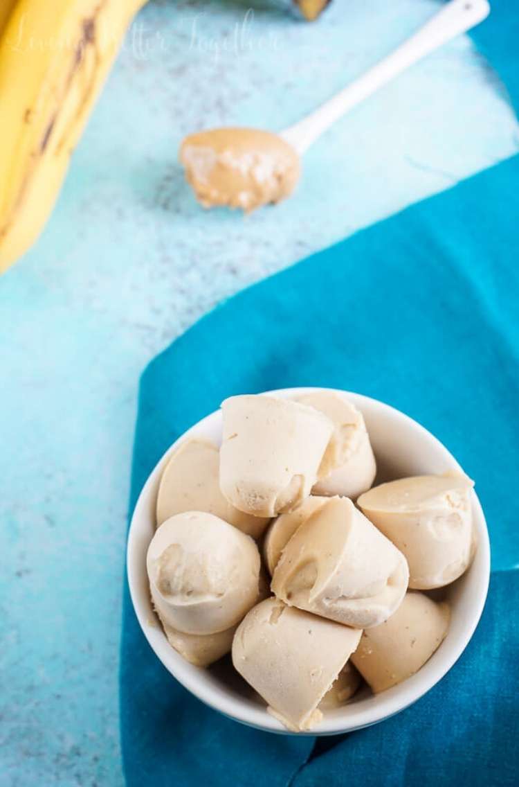 Bowl of Peanut butter and banana treats with spoon with peanut butter in background next to banana