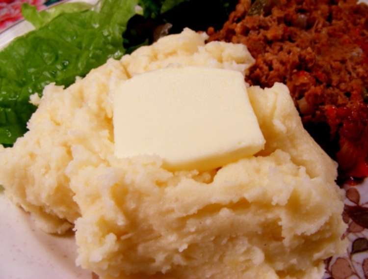 OneCrazyHouse Red Lobster Copycat recipes plate of mashed potatoes with butter square nestled on top, steak and brocolli in background