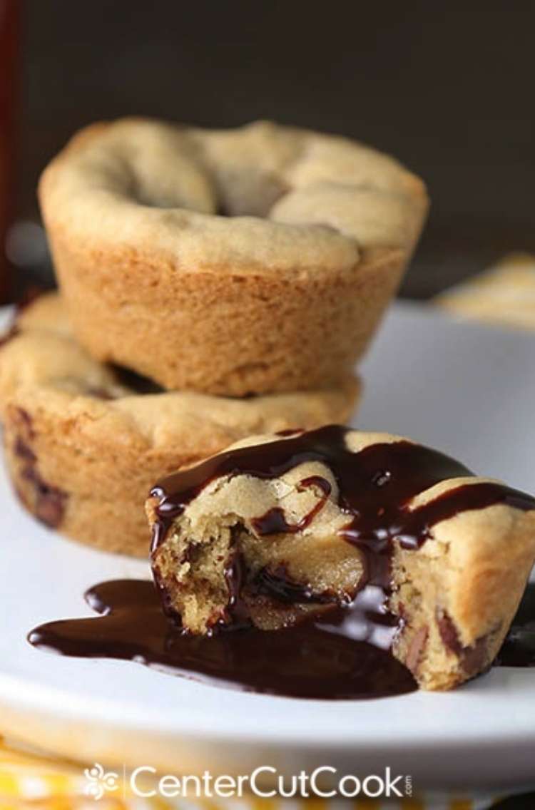 OneCrazyHouse Red Lobster Copycat recipes stack of stuffed chocolate chip cookies. Cookie in front of stack has bite taken out of it with chocolate sauce all around the cookie