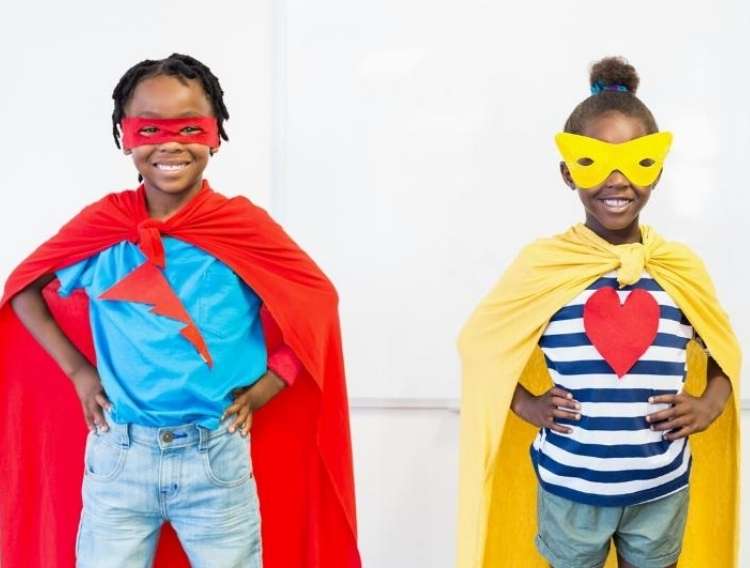 OneCrazyHouse recycled towels 2 kinds smiling at camera wearing recycled towels as superhero capes wearing matching masks with hands on hips in superhero pose