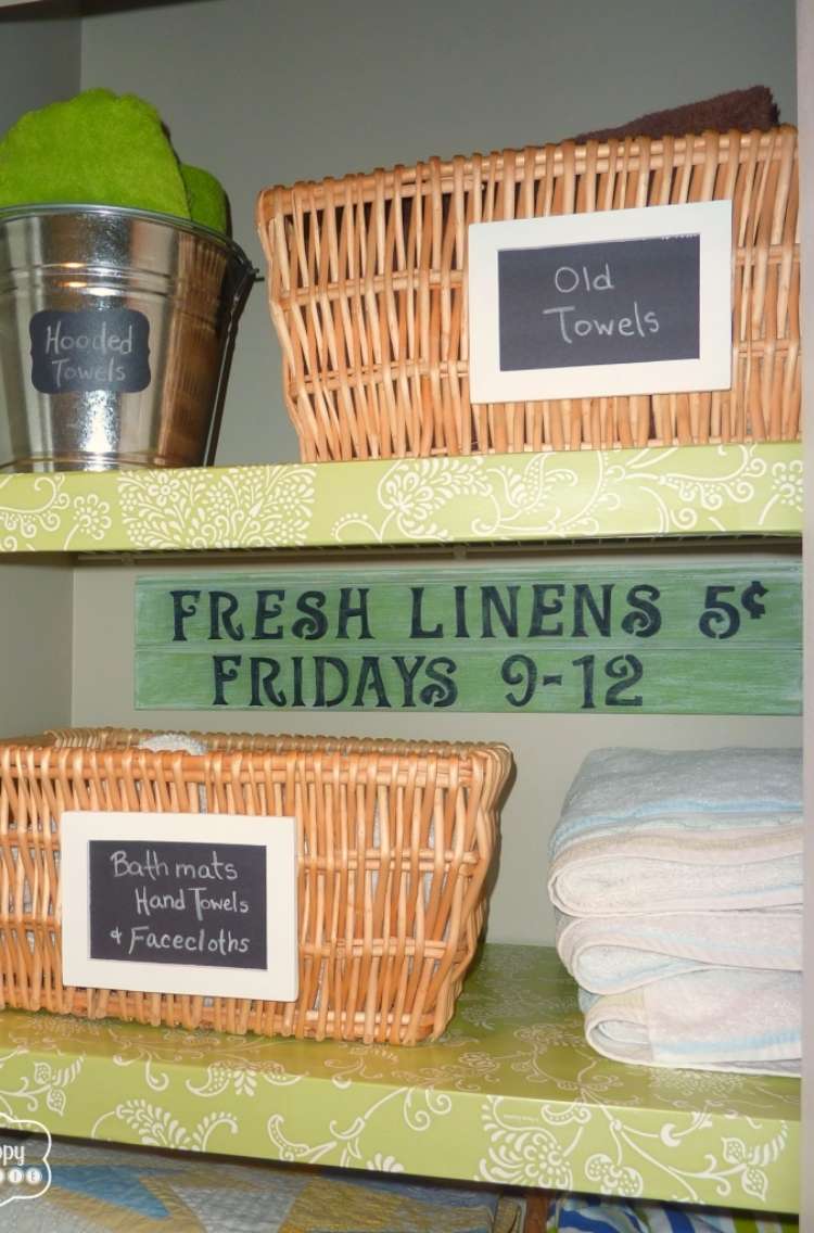 Onecrazyhouse Linen Closet Organization Galvanized bucket with hooded towels on top shelf next to a weaved basket, with another weaved basket and towels next to it on the bottom shelf