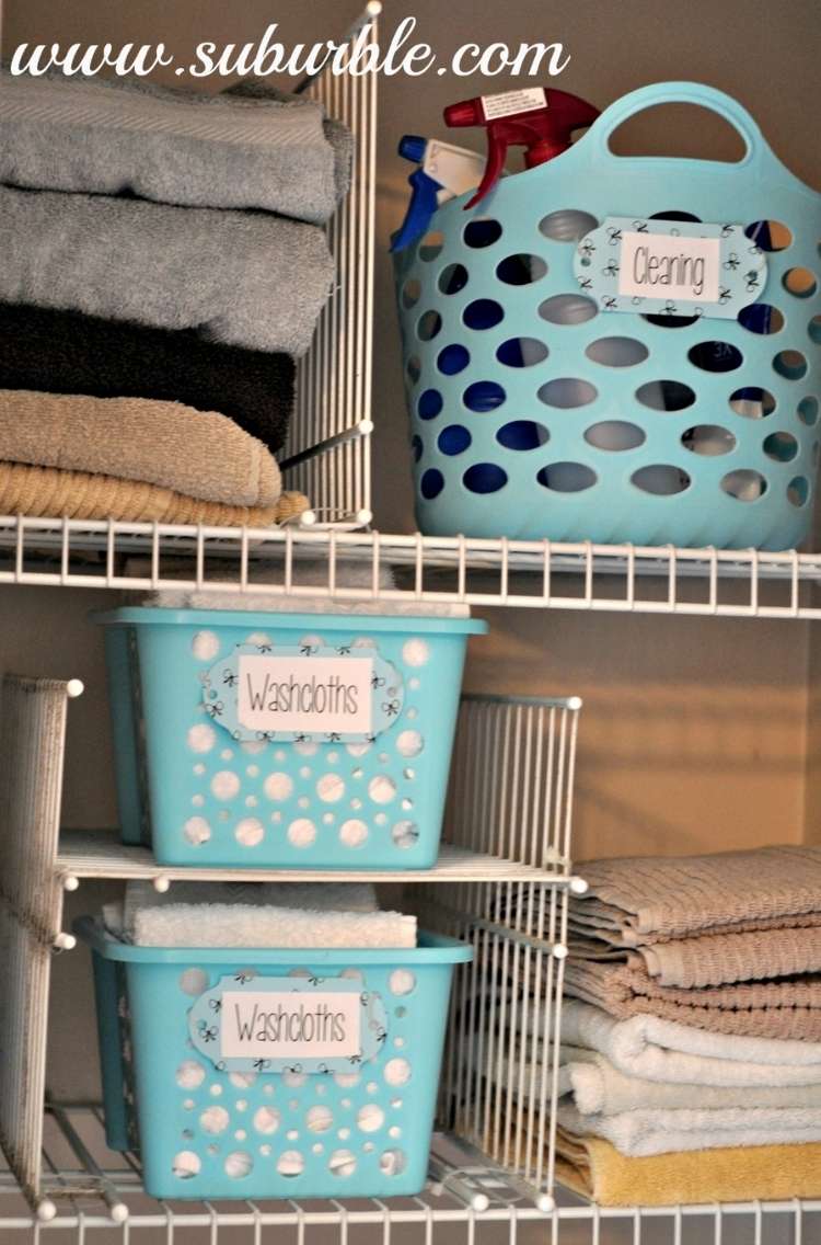 Shelves in a linen closet with baskets, metal shelveing used as dividers for shelf compartments, and creating stackable storage areas