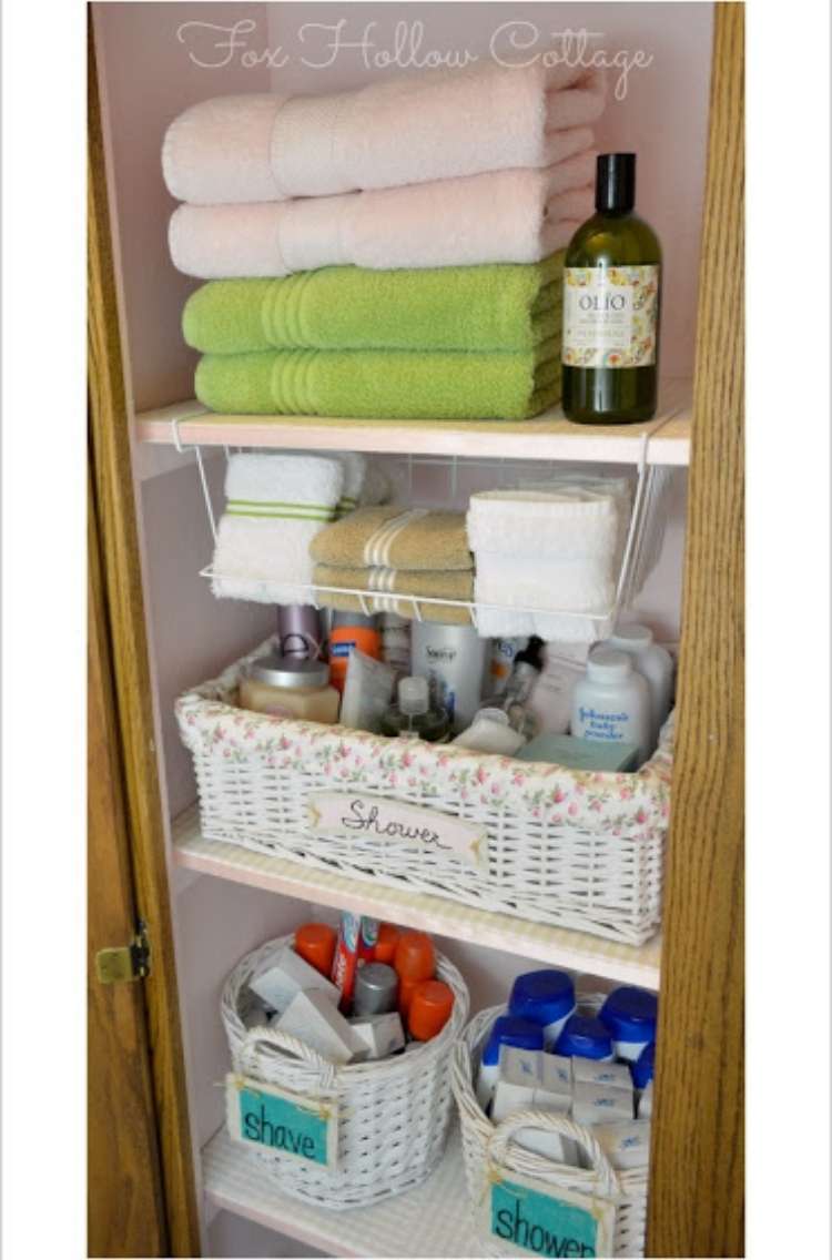 Onecrazyhouse Linen Closet Organization shelves in a linen closet with towels and soap on top shelf, basket on lower shelf and a compartment in between holding hand towels.