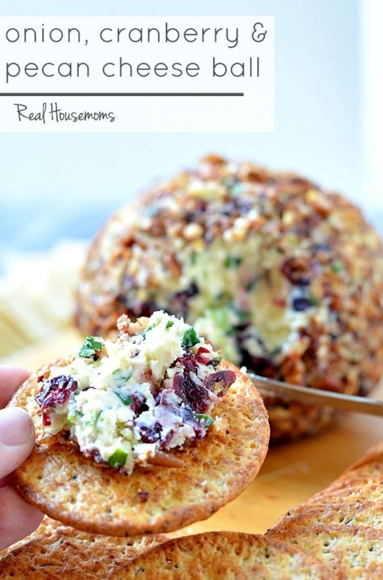 cheese ball and crackers with onions, pecans, cheese and cranberry mixture