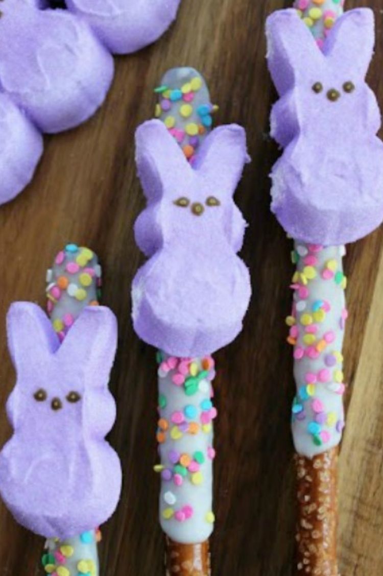 Purple Peeps Bunny marshmallows on top of chocolate covered pretzel sticks