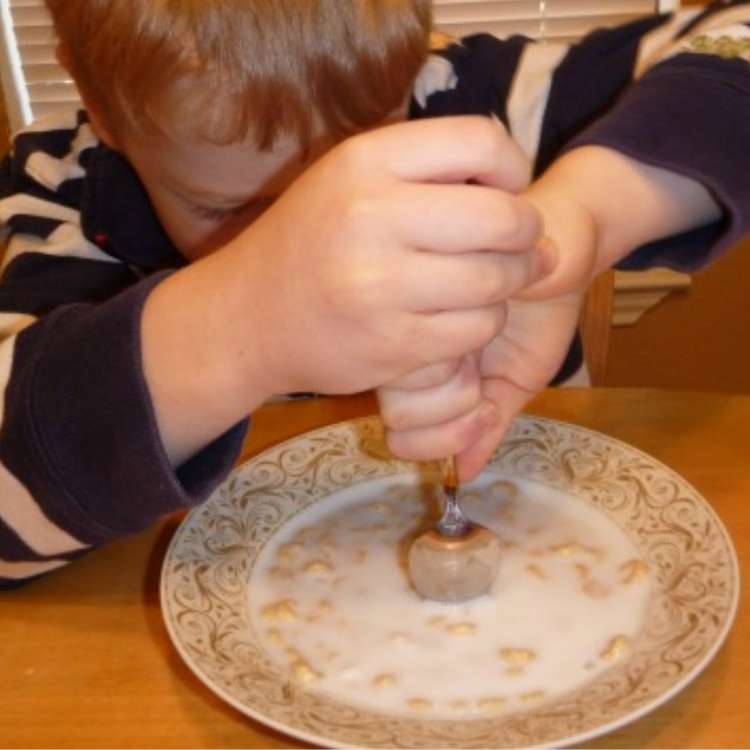 Harmless Prank, little boy trying to get his spoon into a frozen bowl of cereal