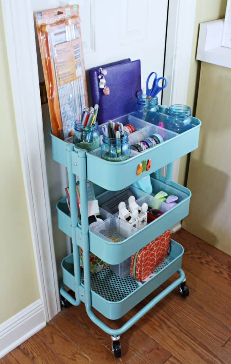 light blue rolling cart with journals, markers, and washi tape