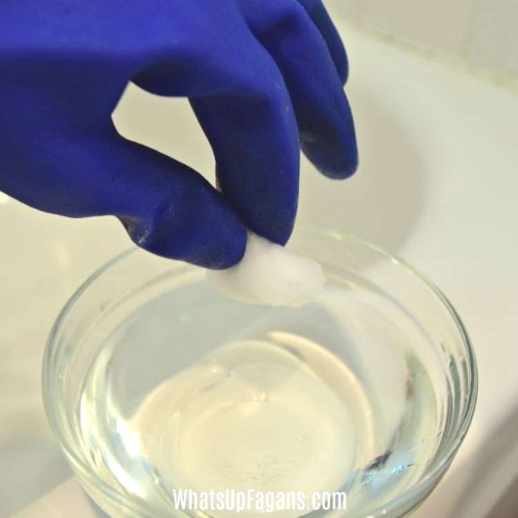 How to clean bathtub - dipping cotton ball into bowl of bleach