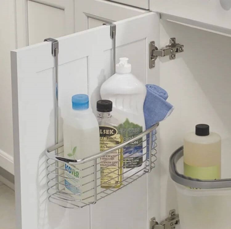 Wire basket hanging over cabinet door to store bottles