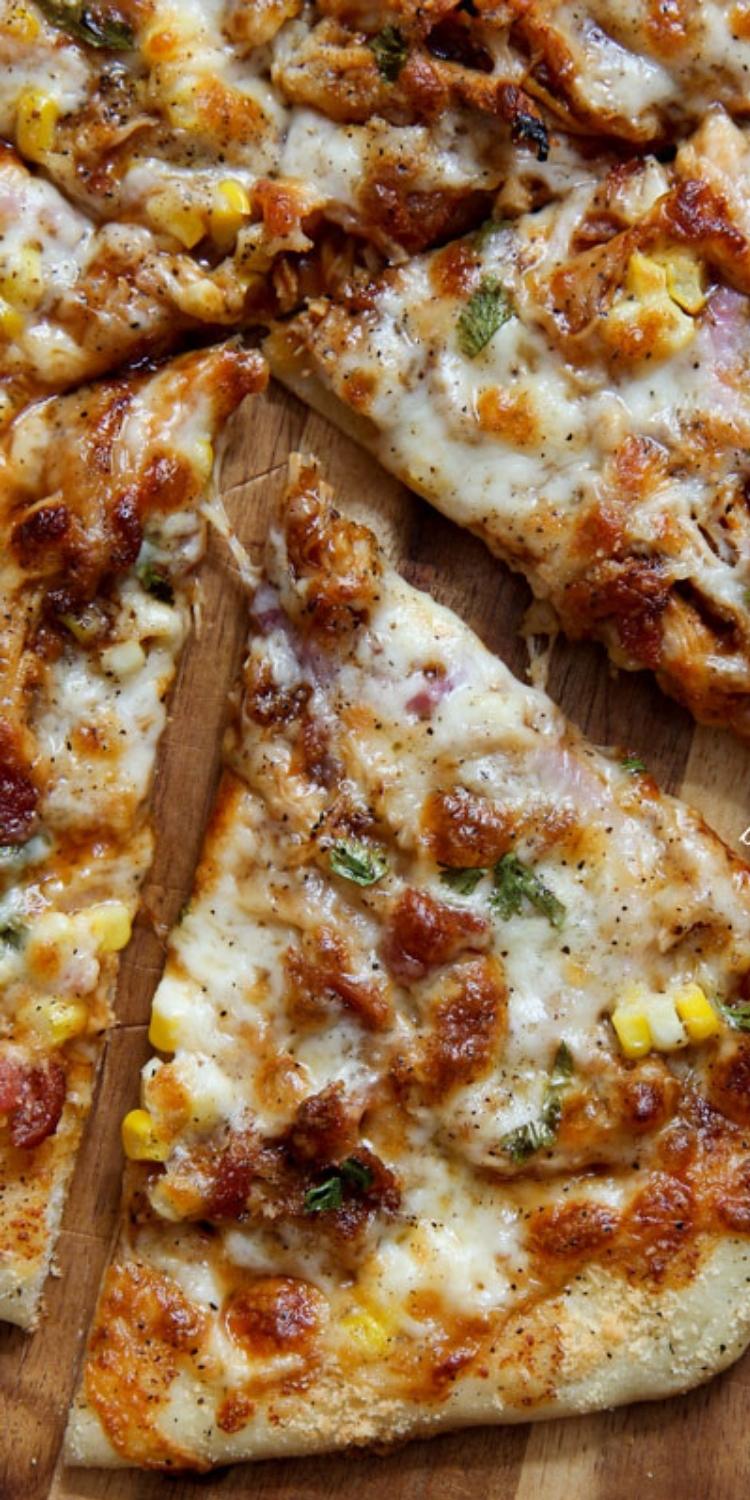 Barbeque bacon and corn atop thin crust pizza. Roasted Corn pizza topping. 