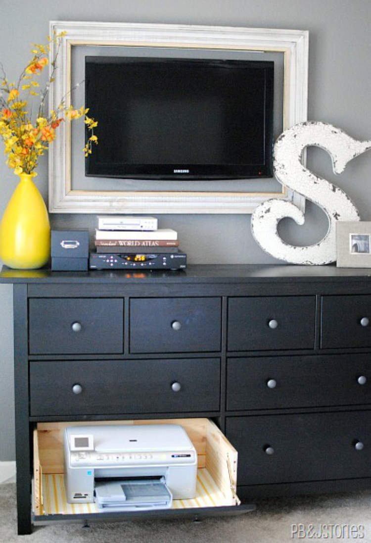 A clever storage idea - printer hidden in an adapted drawer in a wooden cabinet.