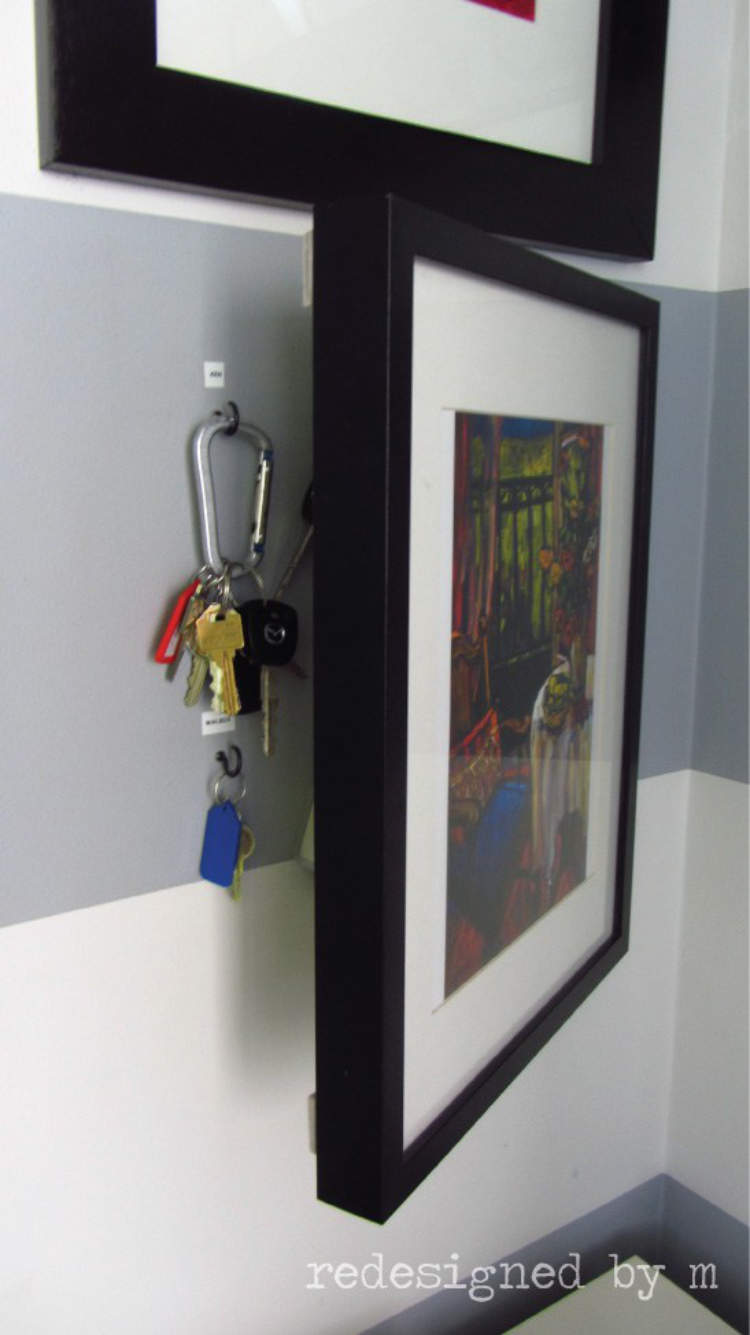 Picture frames on a wall adapted to hide away keys and keep them safely out of sight