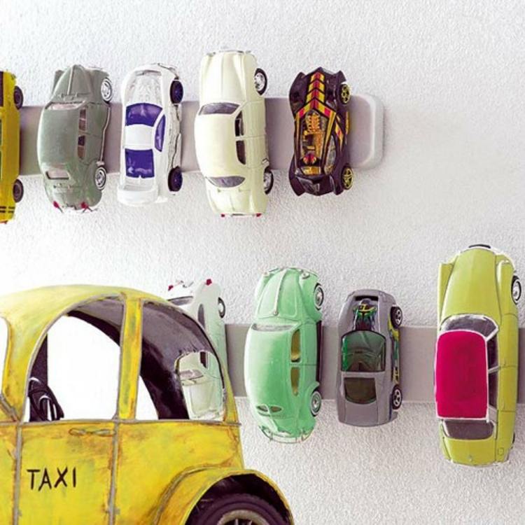 magnetic knife holder used to store toy cars along the wall