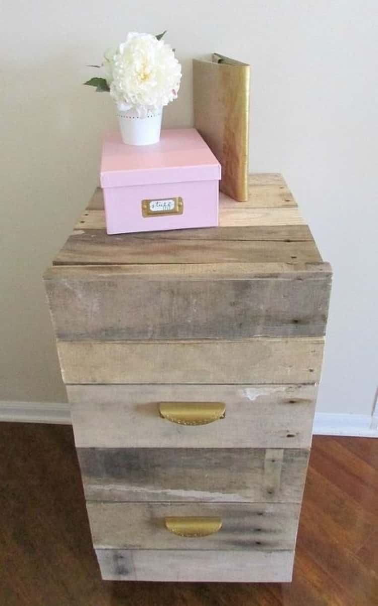 flower bouquet in white vase placed on top of a light pink box on top of an old filing cabinet makeover for home office 