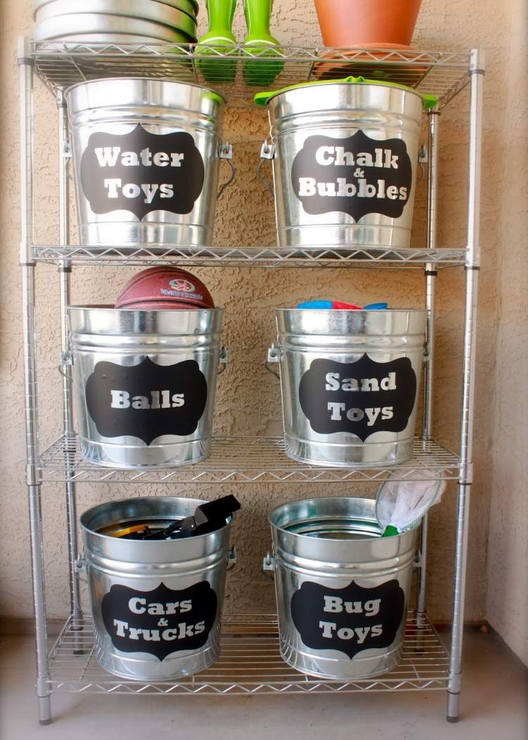 outside toy organization with metal pails on a metal shelf. 