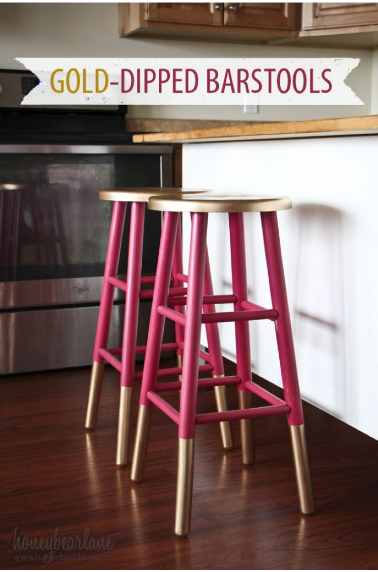 apartment decorating with gold dipped and raspberry colored stool