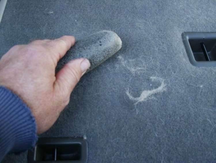 Pumice Block: Man's hand using pumice block on hairy surface