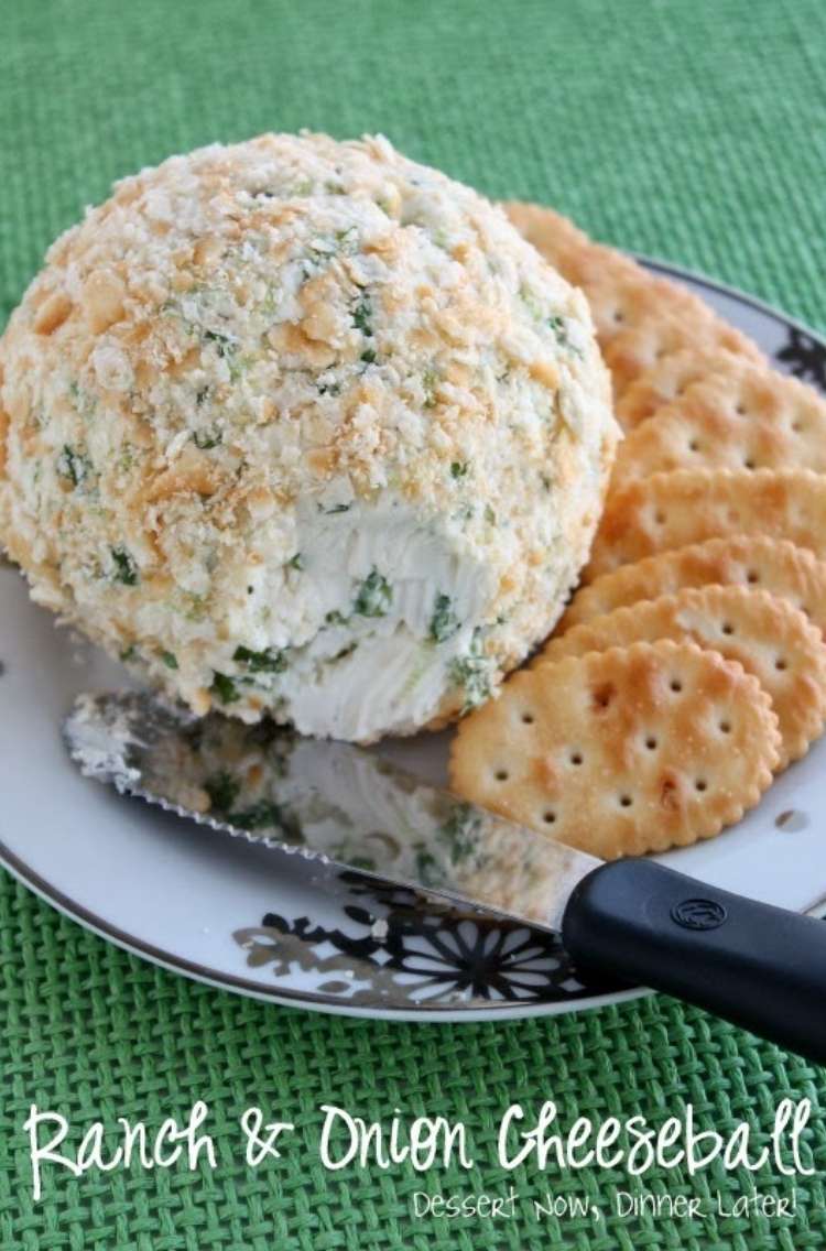 Ranch and onion cheese ball dip and crackers on a plate. 