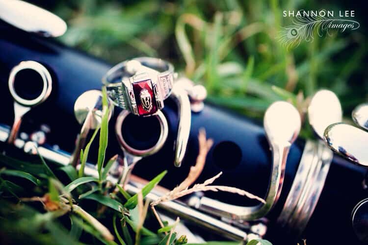 musical instrument placed in the grass with a ring placed on top it it