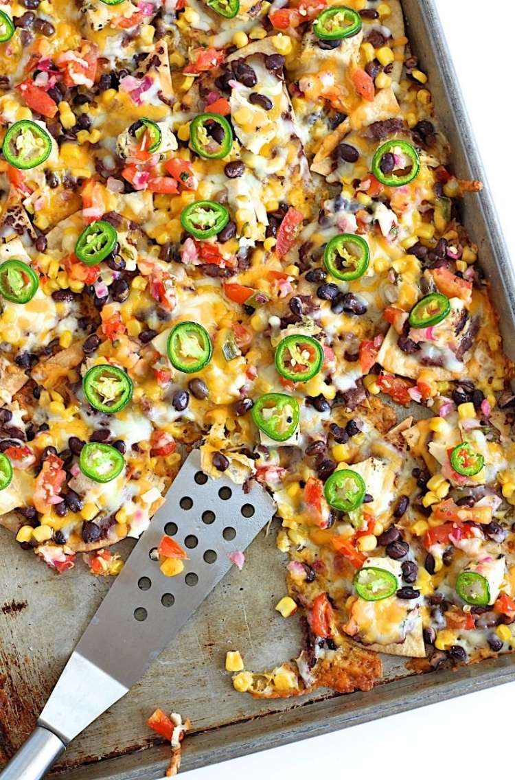 sheet-pan-nacho chips, jalepeno, cheese, and tomatoes in one pan