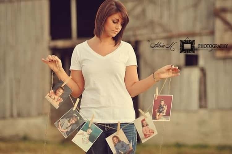 senior picture ideas for girls - woman holding up a garland of growth progression photos 