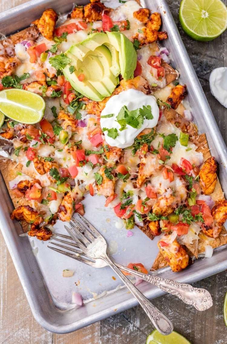 tequila-lime-sheet-pan-chicken-nachos: diced chicken, avocado, chive, cheese, tomato, lime, salsa, sour cream 