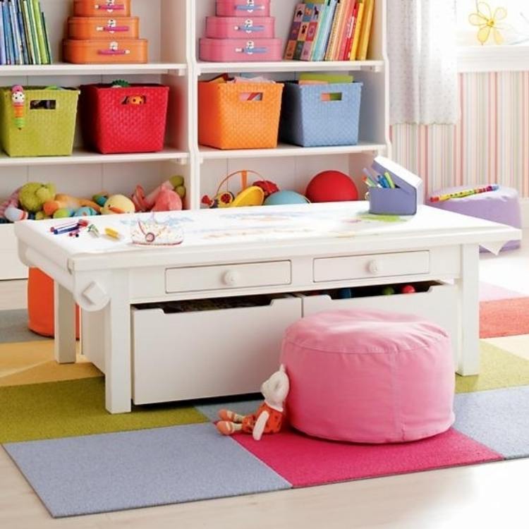 under table storage for toys with a coloring pad on top