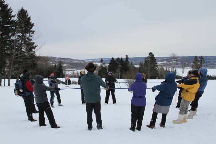 cold-weather-camping image of campers in the snow playing team-builder games 