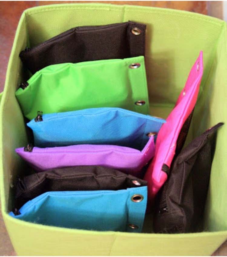 ways to organize toys using fabric box filled with zipper pouches to put puzzle pieces in