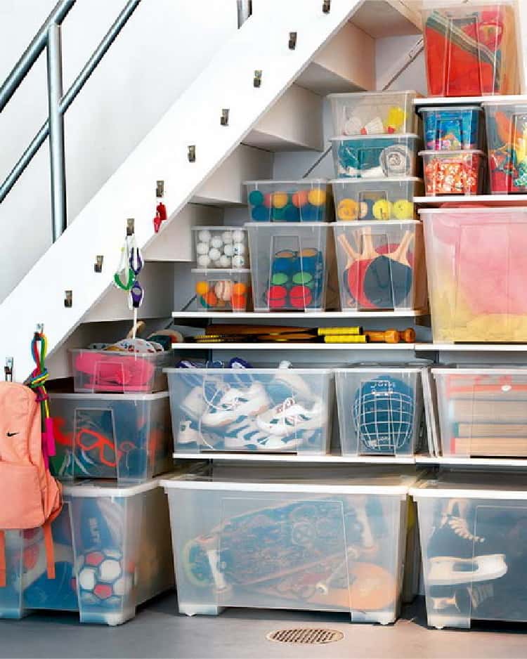 basement under the stairs storage with shelves and containers