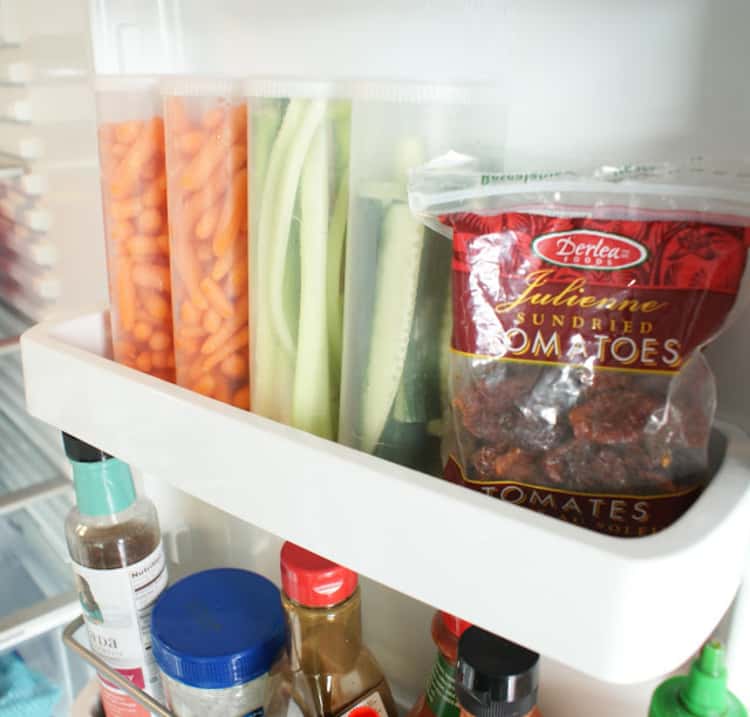 15 Life-Changing Fridge Organization Hacks - Maximize your fridge space by storing cut veggies in vertical containers
