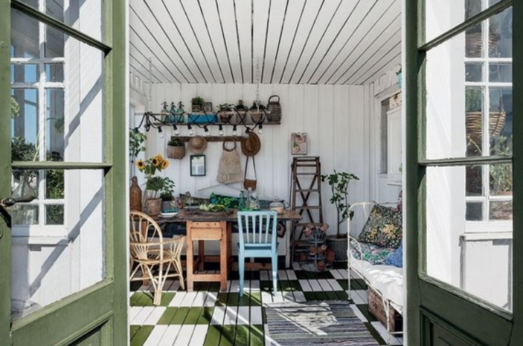 Sunshine filled, light and airy, garden shed with chairs and a bench 