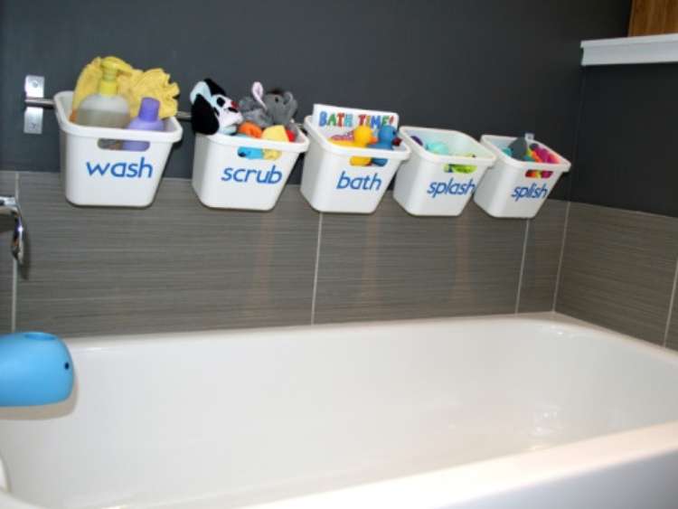 bath tub with buckets hanging from wall