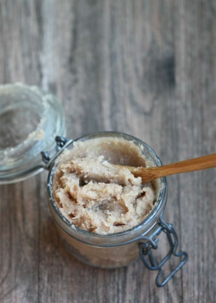 sugar cinnamon honey scrub on a jar with spoon on top a wooden table 