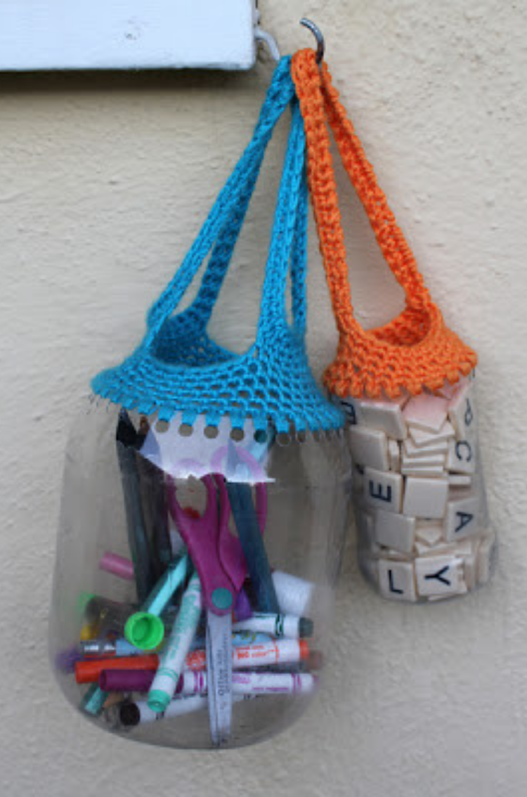 Different size bottles used as necklaces or bags after punching wholes around the open top and crocheting straps around them. 