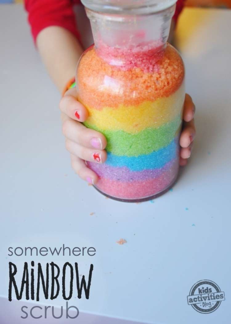 a woman dress in a red dress holding a jar of rainbow scrub for her dry skin 