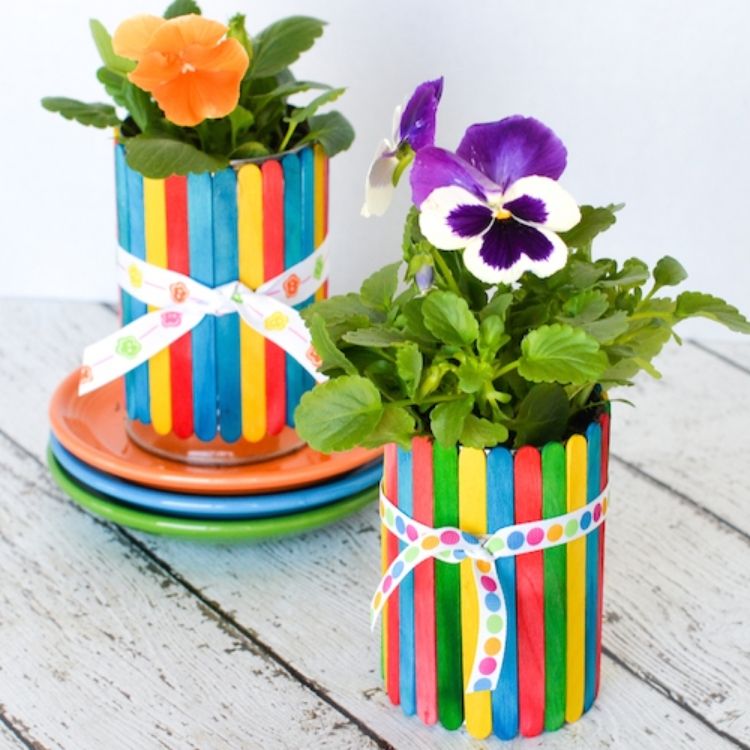 Coloured crafts sticks on tin can for flower pot