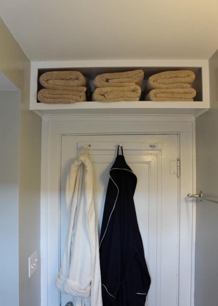 Shelf above door to create extra storage space in small rooms. Hooks on back of door to hold robes.
