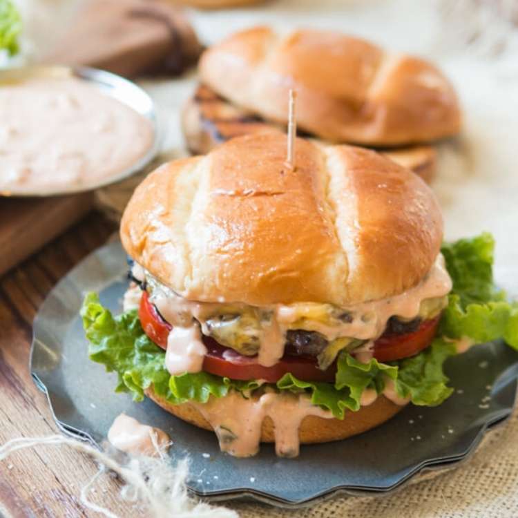 Beef burger topped with lettuce, tomato, cheddar, and a killer burger sauce.