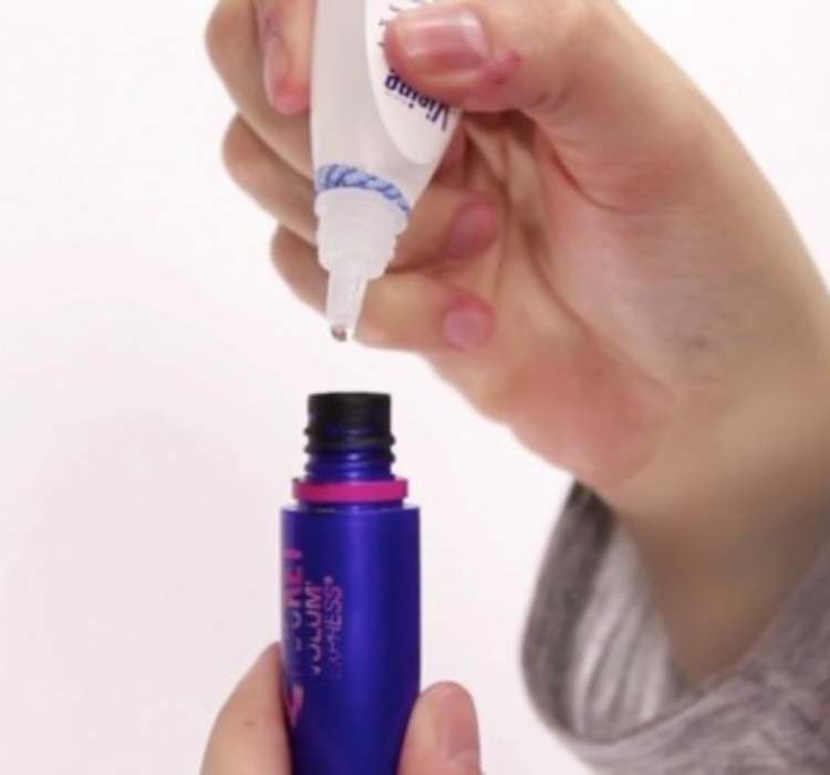 Picture of putting eye drops in mascara to get rid of clumps