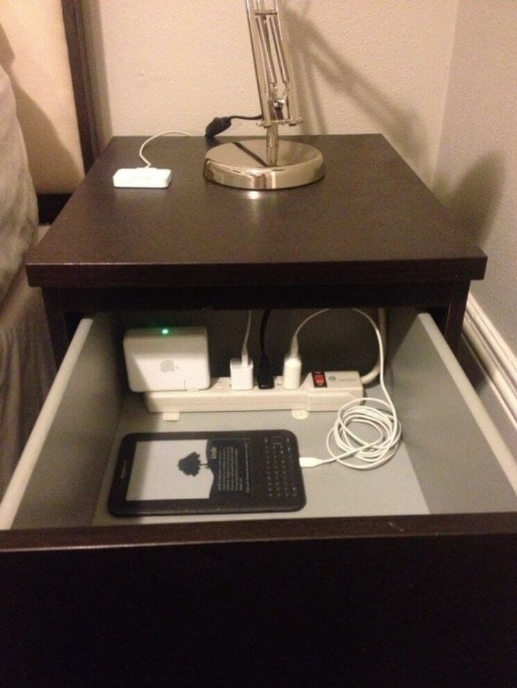 Cable management using an end stand with a hole cut in the back to feed a power strip through allowing all the cords to be inside the drawer