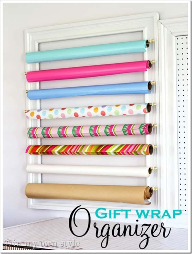 Gift wrap organizer hanging gift wrap rolls on a wall stacked one on top of another horizontally