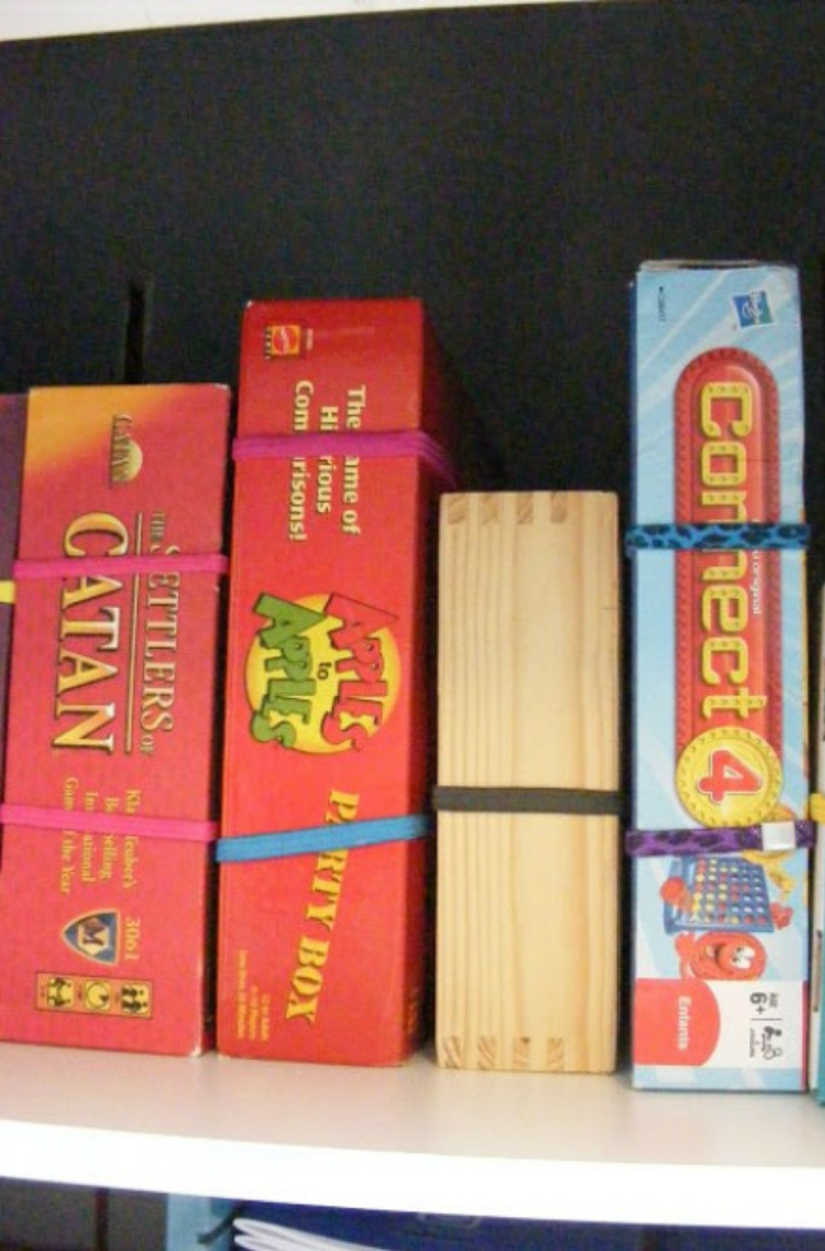Use hair ties and headbands to secure game board boxes shut.