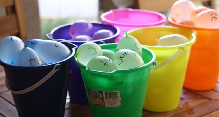 colourful pails full of water balloon words